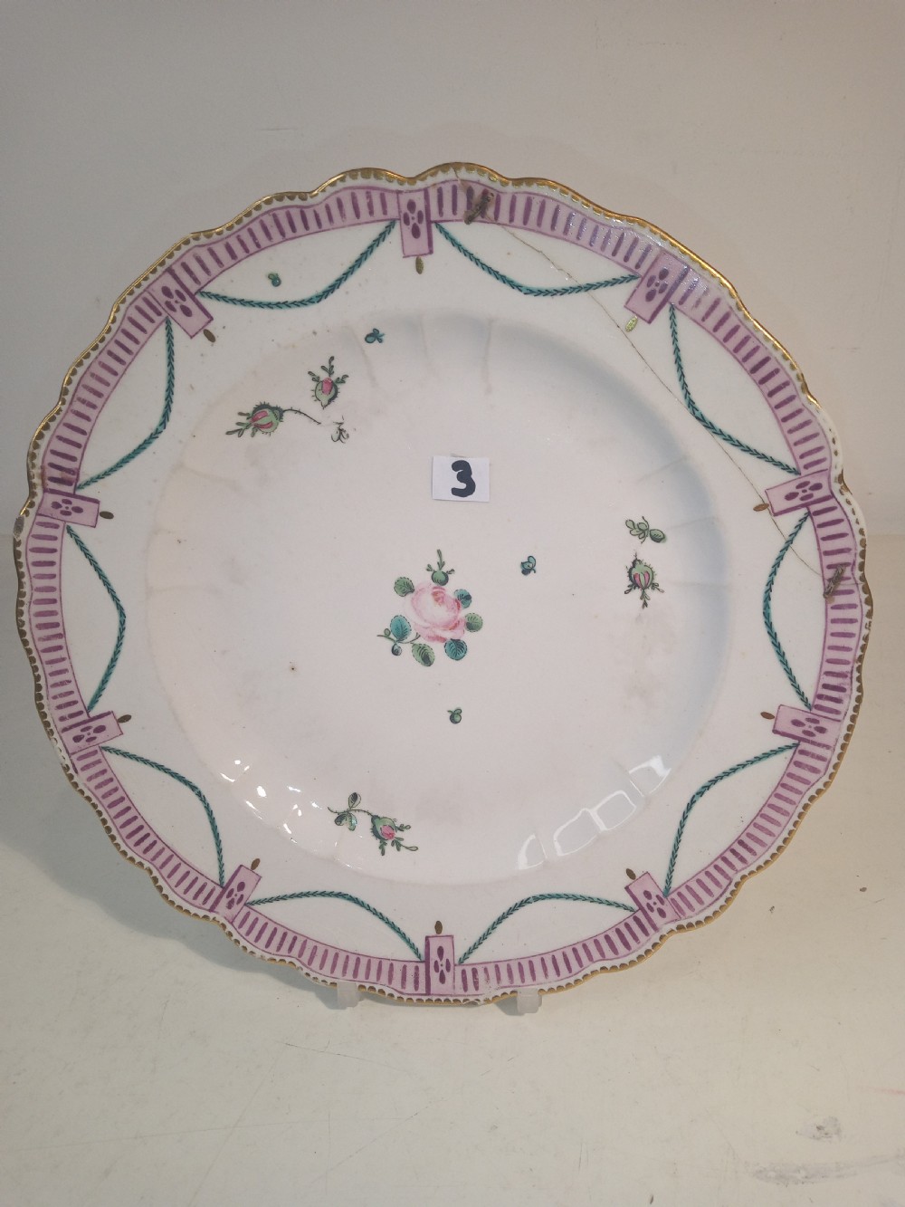 A set of five mid-18th-century Georgian Chelsea soft-paste porcelain plates and shallow bowls decorated with painted floral sprays and pink diaper borders. View XII