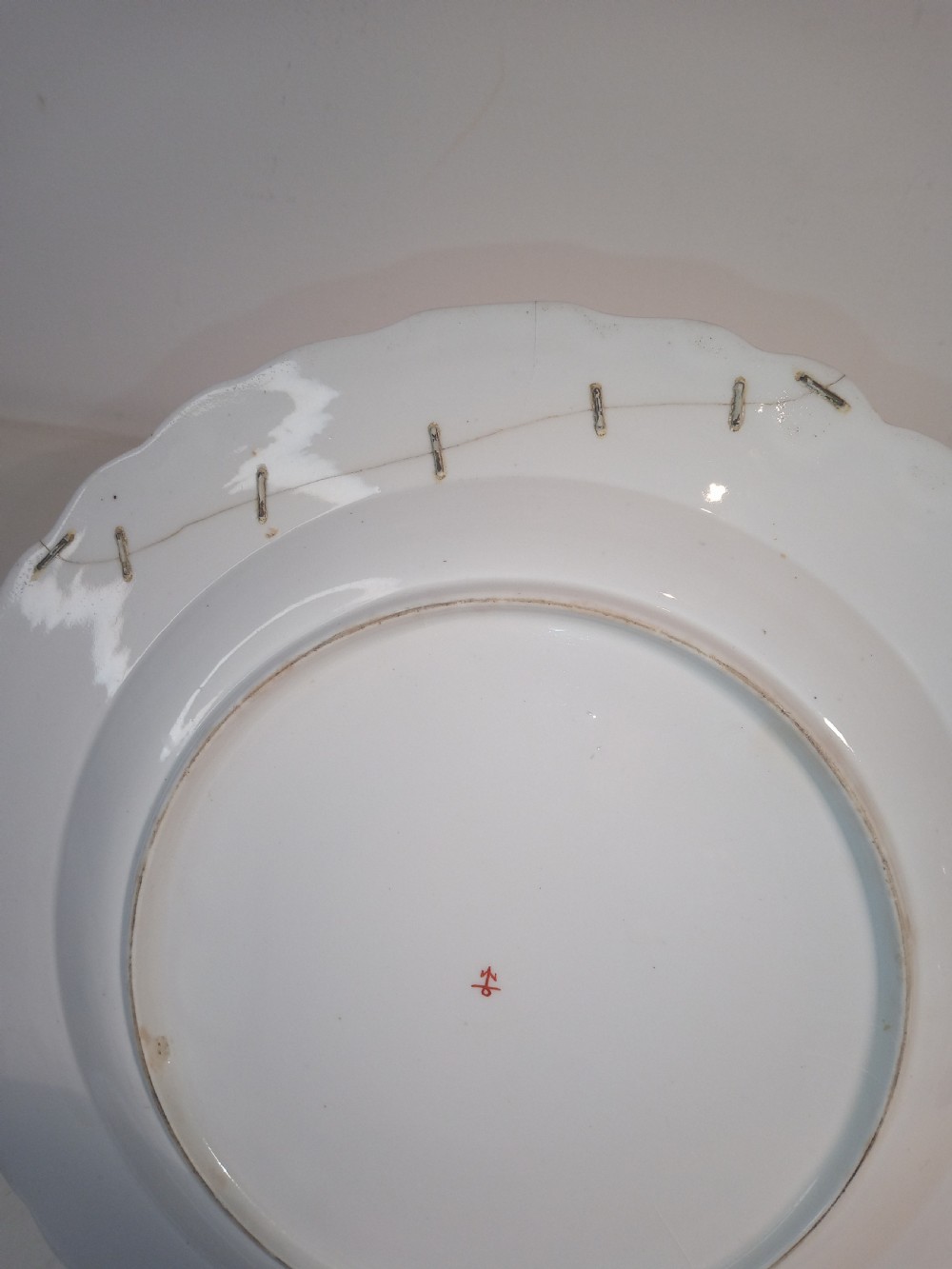 A set of five mid-18th-century Georgian Chelsea soft-paste porcelain plates and shallow bowls decorated with painted floral sprays and pink diaper borders. View XIV