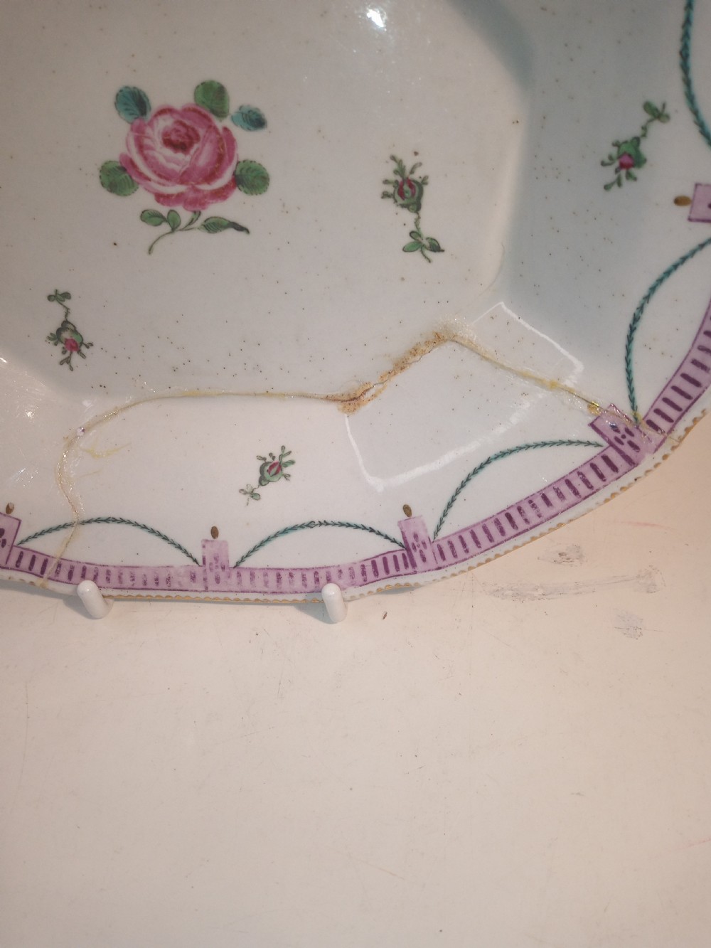 A set of five mid-18th-century Georgian Chelsea soft-paste porcelain plates and shallow bowls decorated with painted floral sprays and pink diaper borders. View XVIII