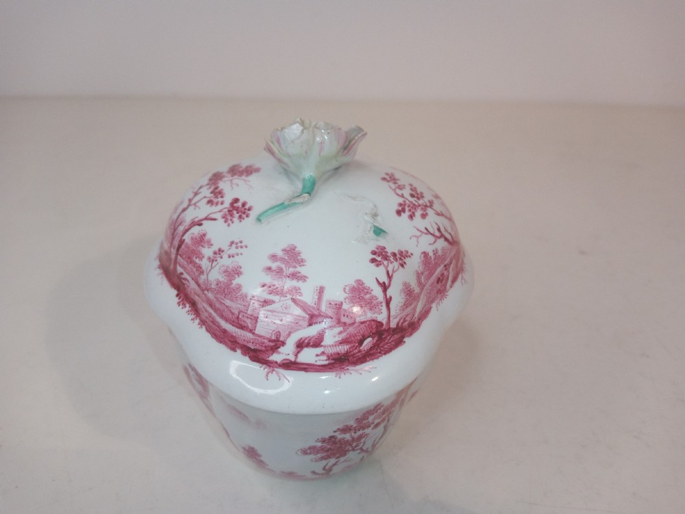 An 18th-century white porcelain lidded sugar bowl decorated with red hand-painted landscape scenes and topped with a sculpted floral finial. View IV