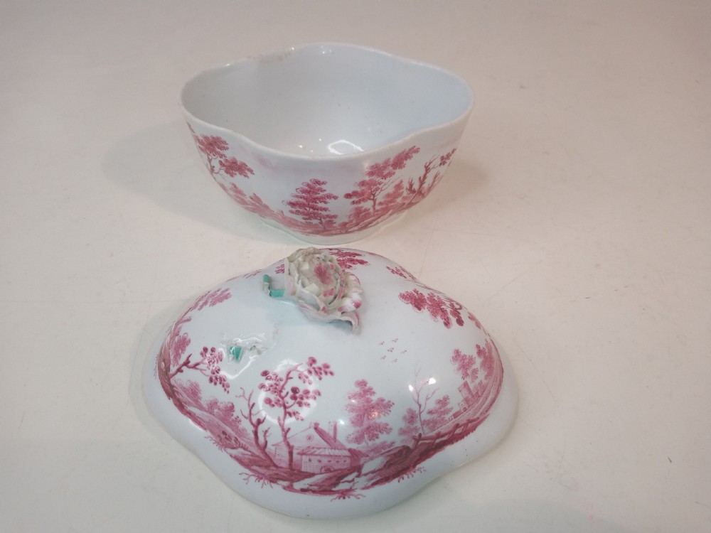 An 18th-century white porcelain lidded sugar bowl decorated with red hand-painted landscape scenes and topped with a sculpted floral finial. View V