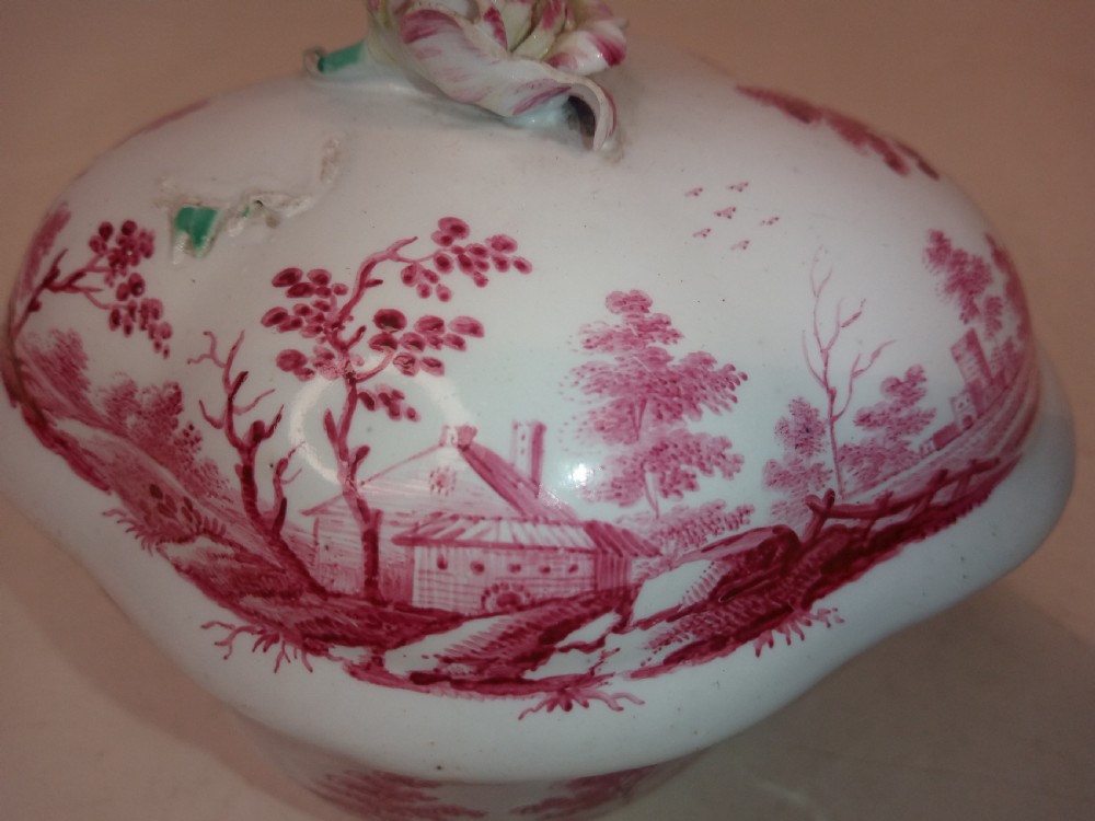 An 18th-century white porcelain lidded sugar bowl decorated with red hand-painted landscape scenes and topped with a sculpted floral finial. View VI