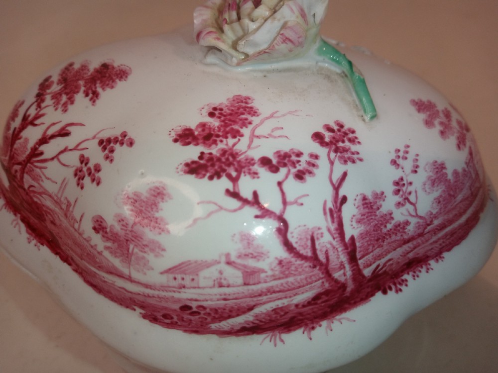 An 18th-century white porcelain lidded sugar bowl decorated with red hand-painted landscape scenes and topped with a sculpted floral finial. View VII