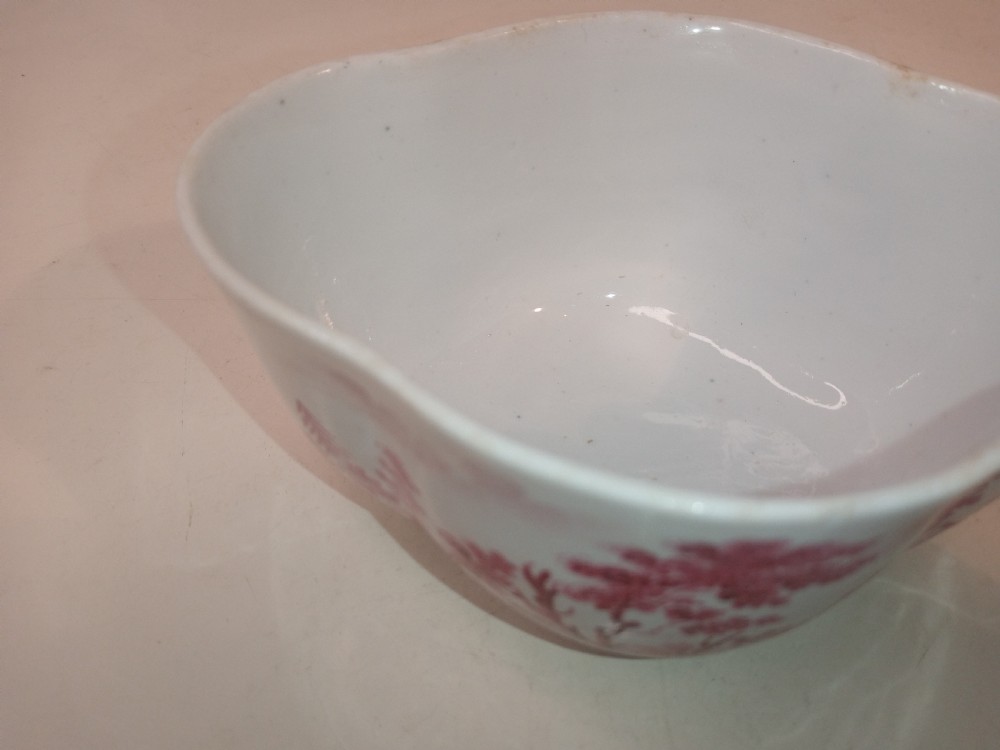 An 18th-century white porcelain lidded sugar bowl decorated with red hand-painted landscape scenes and topped with a sculpted floral finial. View X