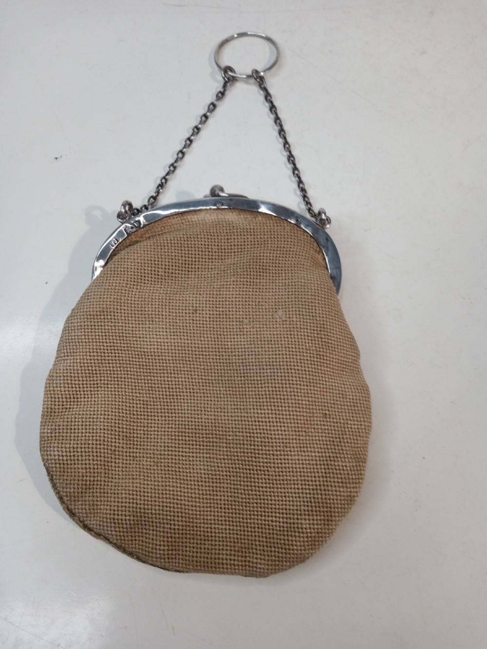 Late Victorian sterling silver evening purse featuring a pierced silver frame with a chain handle and a beige petit point needlepoint pouch with pink and yellow floral embroidery. View II
