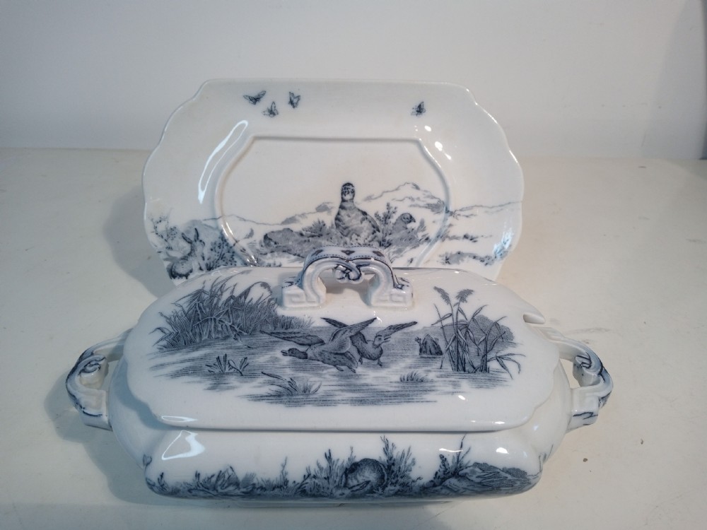 A Victorian Staffordshire earthenware tureen and matching stand with blue and white transferware illustrations of waterfowl and rabbits. View III