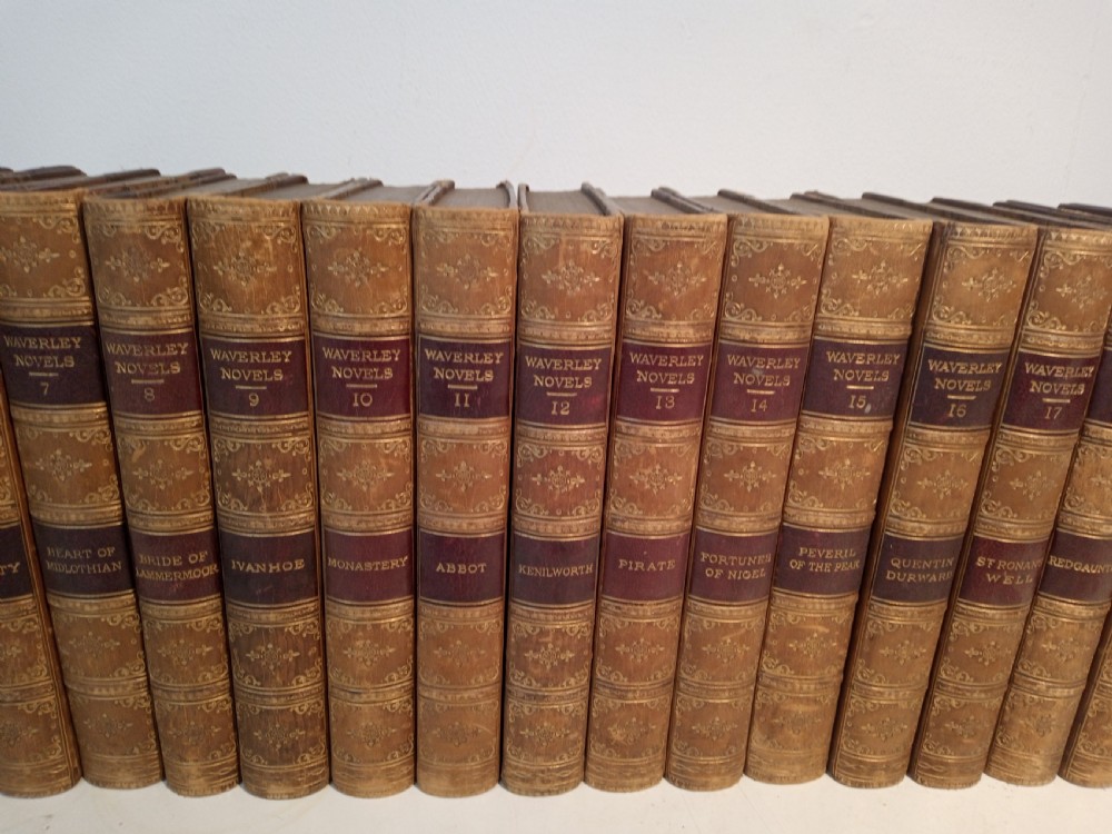 A complete set of 25 Victorian leather-bound Waverley Novels arranged side by side with gilt tooling and red title blocks along the spines. View III