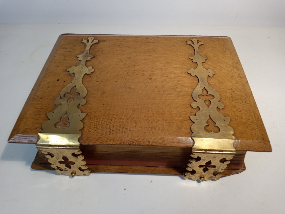 A mid-nineteenth-century Holy Bible featuring a brown leather spine with raised bands and ornate brass mounts over wooden covers. View VII