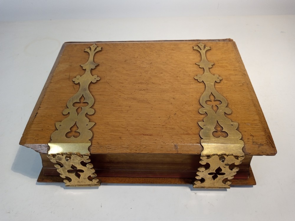 A mid-nineteenth-century Holy Bible featuring a brown leather spine with raised bands and ornate brass mounts over wooden covers. View VIII