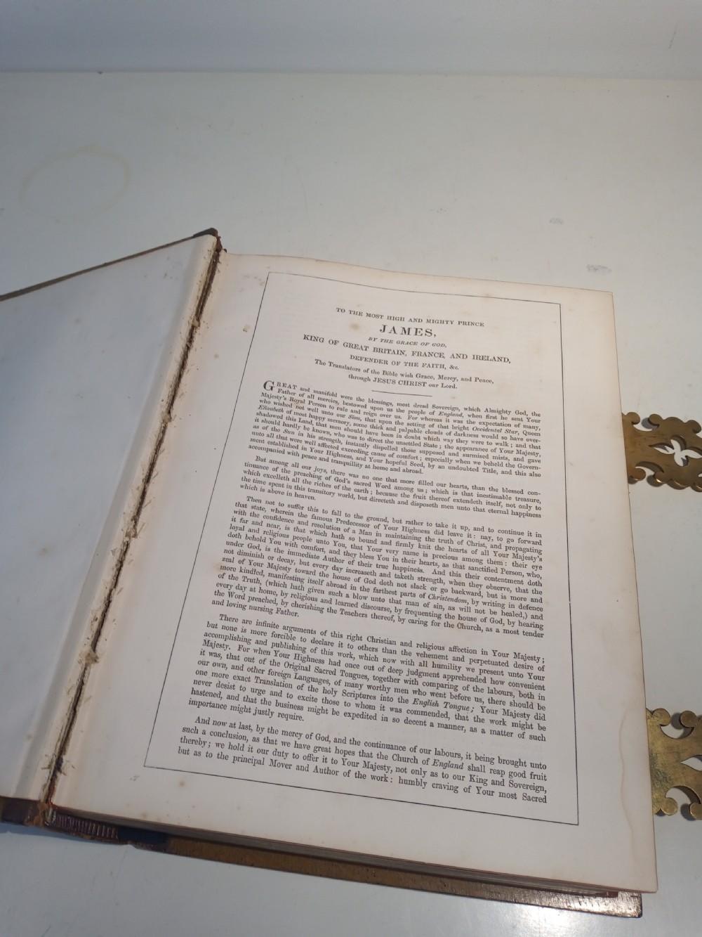 A mid-nineteenth-century Holy Bible featuring a brown leather spine with raised bands and ornate brass mounts over wooden covers. View XIII