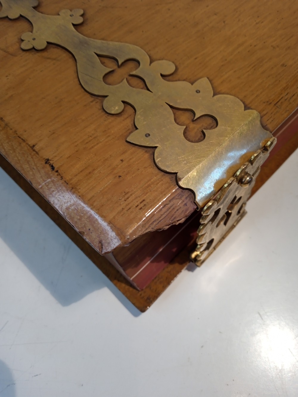 A mid-nineteenth-century Holy Bible featuring a brown leather spine with raised bands and ornate brass mounts over wooden covers. View XIV