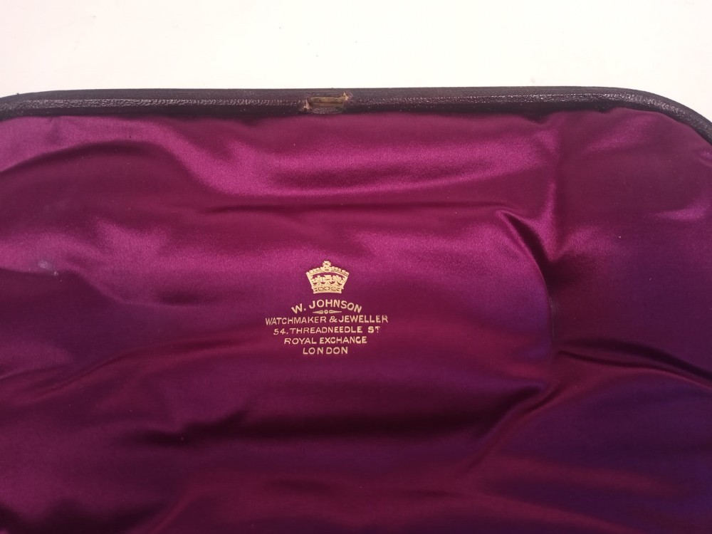 A dark presentation case lined with purple silk containing two embossed silver-gilt berry spoons and a pierced sugar sifter spoon. View VIII