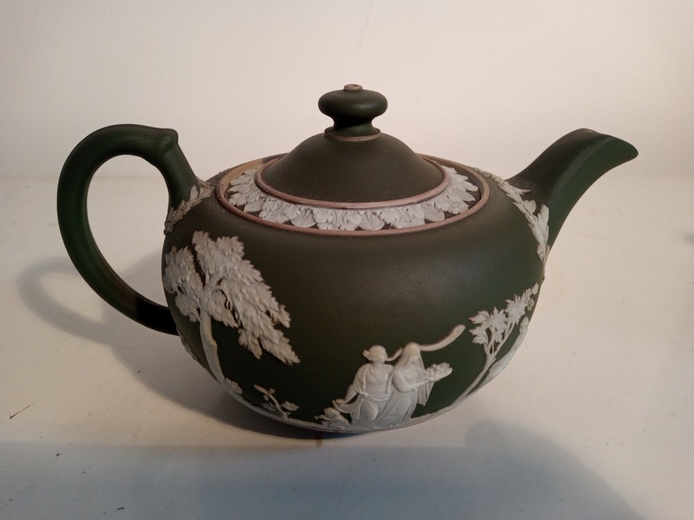 A late nineteenth-century three-piece olive green Wedgwood jasperware bachelor tea set adorned with white Neoclassical relief figures and foliage. View II