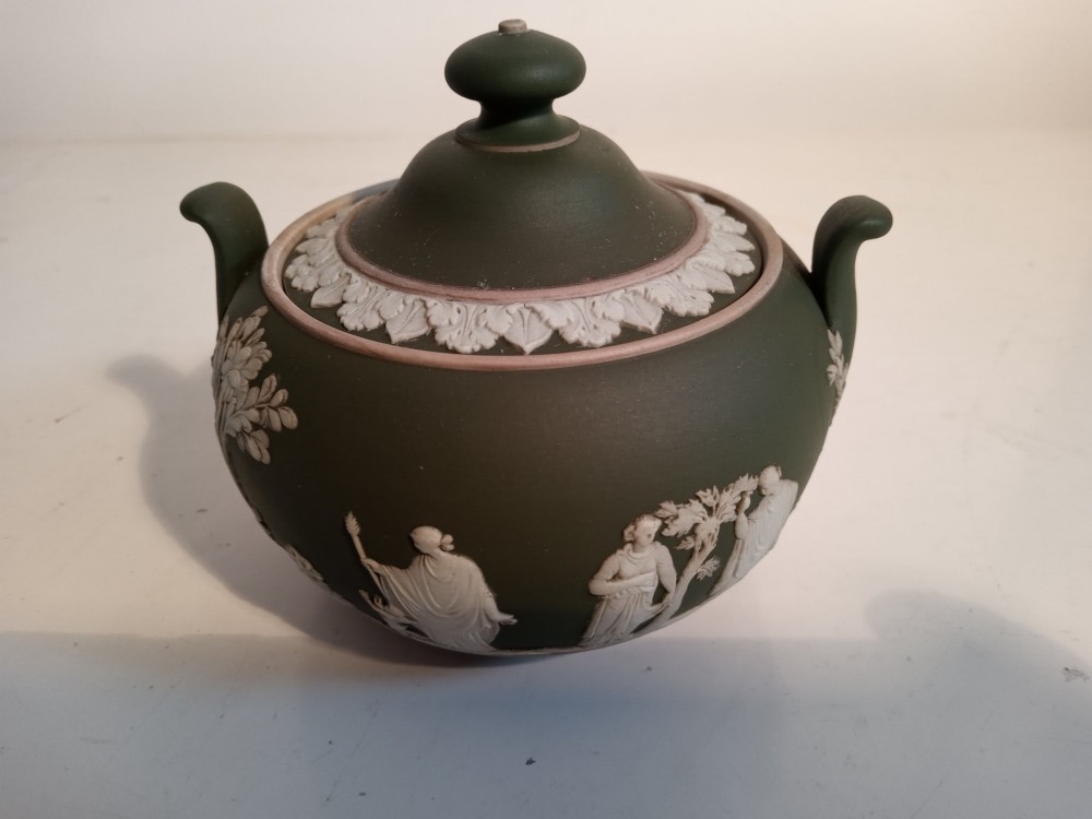 A late nineteenth-century three-piece olive green Wedgwood jasperware bachelor tea set adorned with white Neoclassical relief figures and foliage. View VI
