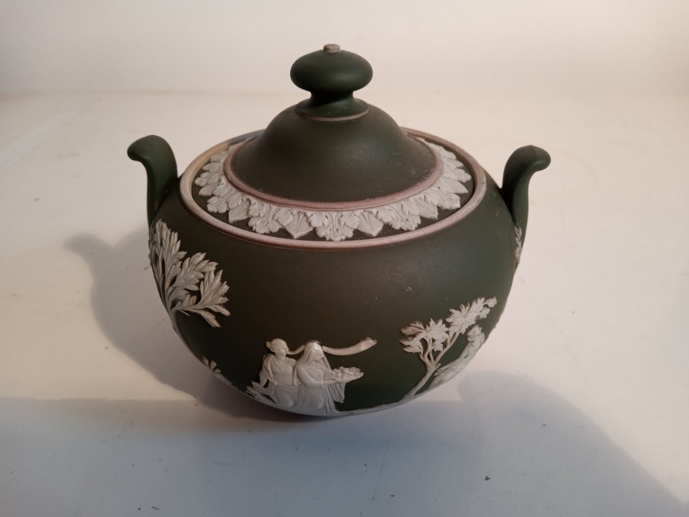 A late nineteenth-century three-piece olive green Wedgwood jasperware bachelor tea set adorned with white Neoclassical relief figures and foliage. View VII