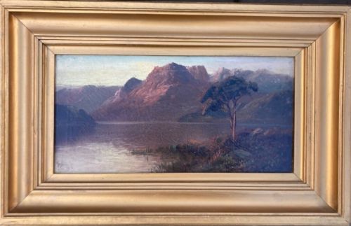 fig 1. An antique oil painting on canvas depicting a Scottish highland landscape with mountains, a loch, and a tree.