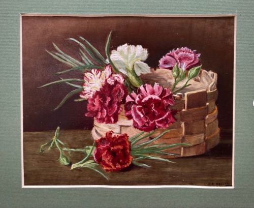 fig 1. An antique oil painting on card depicting carnations in a woven basket, set within a dark frame with a green mount.