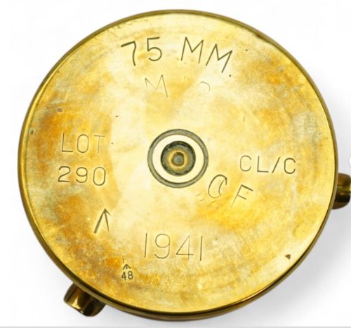 fig 1. Circular brass trench art ashtray formed from a shell casing with three cigarette rests and a central star-shaped military emblem.