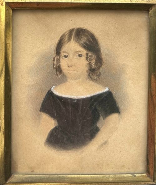 fig 3. An early nineteenth-century watercolour portrait miniature of a young girl with brown hair, presented in a square ebonised frame with a gilt inner slip and top brass hanger.