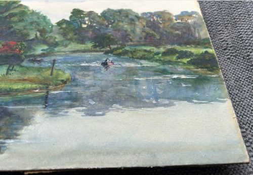 An early 20th-century watercolour landscape painting portraying Warkworth Castle rising above cottages alongside a calm river with a small boat. View VII