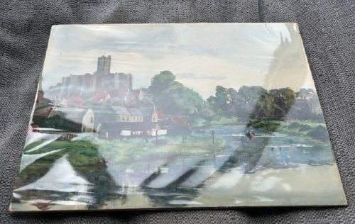 An early 20th-century watercolour landscape painting portraying Warkworth Castle rising above cottages alongside a calm river with a small boat. View X