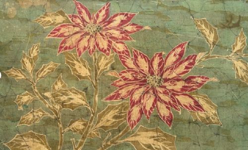 fig 3. A horizontal framed batik textile artwork displaying red and cream poinsettia flowers with foliage against a crackled sage green background.
