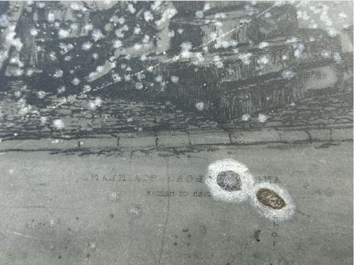 fig 1. An early nineteenth-century rectangular dark metal printing plate depicting an etched historical scene of figures near a stone monument in Halifax.