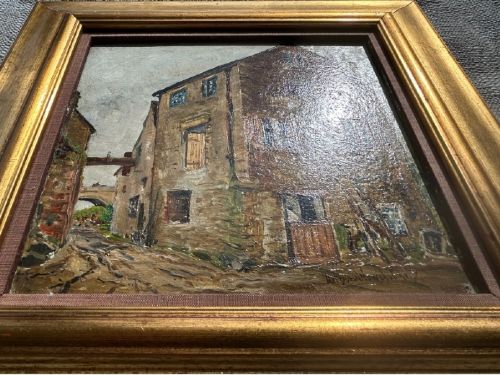 An early twentieth-century oil painting on panel depicting a stone mill building, framed within a fabric slip and a moulded giltwood frame. View X