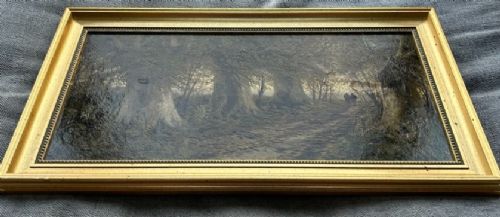 A late 19th-century framed oil painting depicting two small figures walking along a wooded path surrounded by mature trees in an autumn landscape. View XI