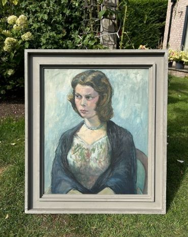 fig 1. A mid-century oil painting on canvas depicting a seated woman wearing a patterned dress, blue necklace, and dark shawl, framed in a grey wooden frame.