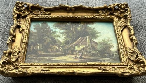 An antique oil painting on panel depicting a rural British cottage surrounded by trees, set within an ornate gilt frame. View VIII