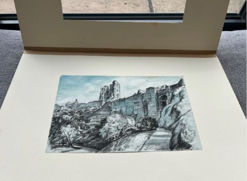 A 1934 monochrome blue watercolour and ink drawing depicting Scarborough Castle ruins atop a hillside with stone curtain walls and pathways. View V