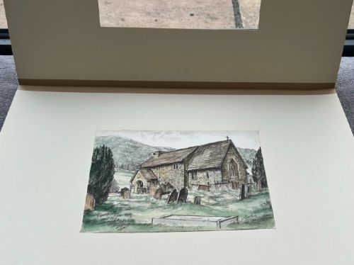 A 1934 watercolour and ink painting depicting St Hildas stone church and churchyard in Ellerburn, North Yorkshire, set against hills. View III