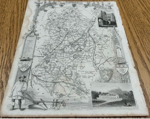 fig 1. A 19th-century monochrome steel-engraved map of Bedfordshire framed by intricate Gothic architectural arches and regional vignettes including Woburn Abbey.