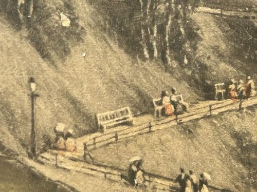 An 1890 monochrome autotype print depicting Victorian figures gathered on a cliff overlooking Scarborough beach and coastal bay. View XI