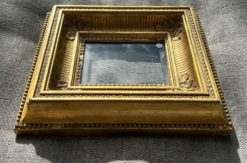 fig 2. A square, deep-profile antique giltwood picture frame featuring fluted channel moulding and carved acanthus leaf corner ornaments.