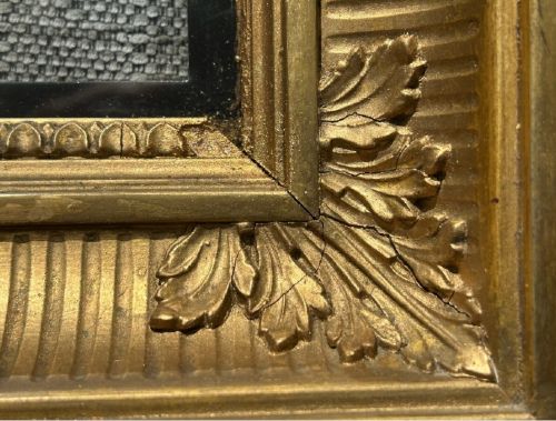 A square, deep-profile antique giltwood picture frame featuring fluted channel moulding and carved acanthus leaf corner ornaments. View VI