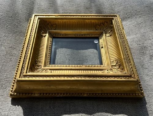 fig 1. An antique square giltwood picture frame featuring fluted hollow moulding, acanthus leaf corner ornaments, and beaded inner borders.