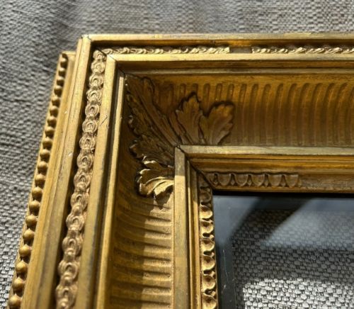 An antique square giltwood picture frame featuring fluted hollow moulding, acanthus leaf corner ornaments, and beaded inner borders. View VI