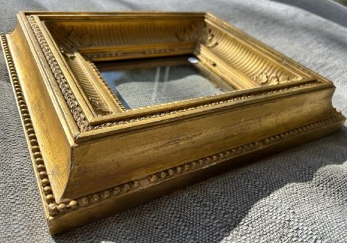 An antique square giltwood picture frame featuring fluted hollow moulding, acanthus leaf corner ornaments, and beaded inner borders. View VIII