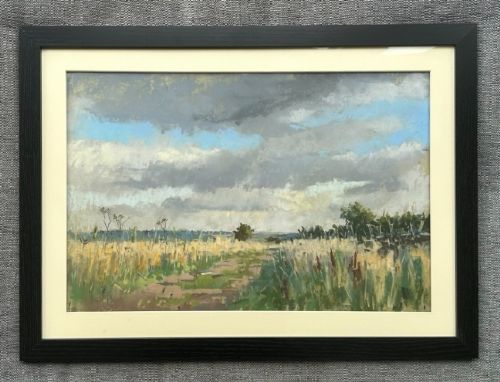 fig 1. A framed pastel painting depicting a grassy pathway through fields under a cloudy blue sky, housed in a dark frame with a light mount.