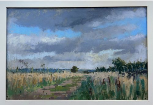 A framed pastel painting depicting a grassy pathway through fields under a cloudy blue sky, housed in a dark frame with a light mount. View VII