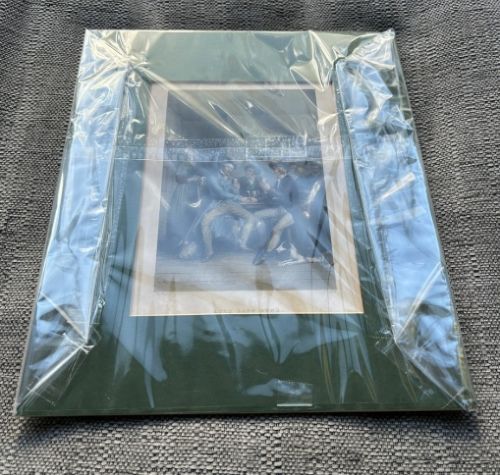 A pair of early nineteenth-century hand-coloured engravings featuring figurative scenes mounted in dark green card. View V