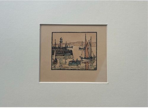 An early 20th-century miniature woodblock print depicting St Ives harbour with a lighthouse, sailing vessels, a rowboat, and coastal hills printed in ink on beige paper. View IV