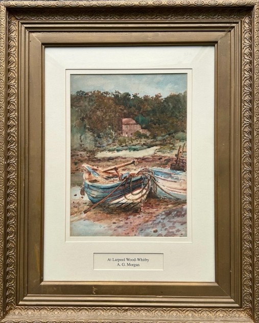 An antique watercolour painting depicting wooden boats along the River Esk near Whitby, presented in a gold gilt frame with a white mount. View XII