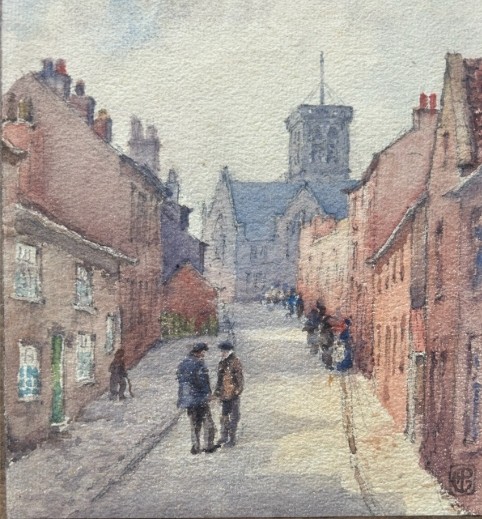 An antique watercolour painting depicting figures on a sloping street flanked by brick buildings leading towards a church tower. View IV