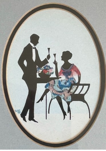 An Art Deco framed silhouette picture featuring a couple holding glasses, set within an oval mount and a wide burr wood frame. View II