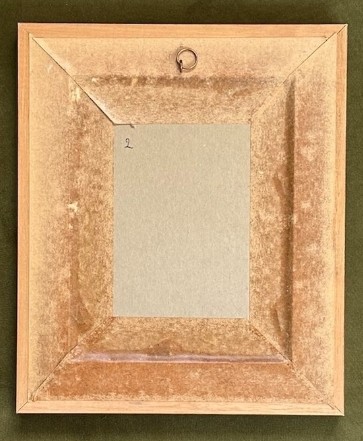 An Art Deco framed silhouette picture featuring a couple holding glasses, set within an oval mount and a wide burr wood frame. View IV