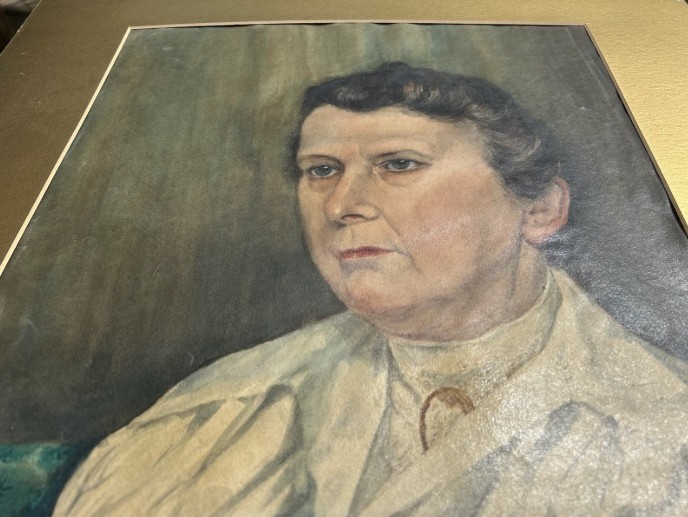 An original 1921 gouache and watercolour portrait painting of a woman in a cream blouse set against a muted green background. View VIII