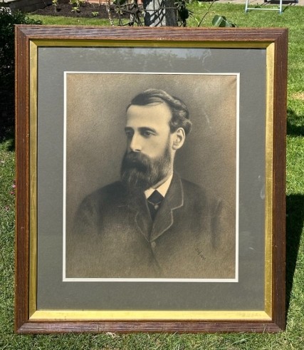 A framed late 19th-century charcoal portrait depicting a bearded gentleman in formal attire.